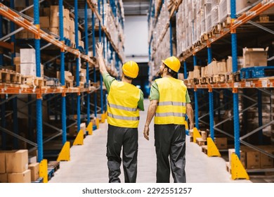 A warehouse manager explaining to new warehouseman organization of box and goods in storage. - Powered by Shutterstock