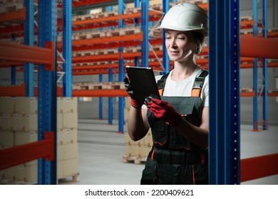 Warehouse Manager Is Holding Tablet. Woman Among Storage Racks. Girl Works In Logistics Center. Logistics Warehouse Manager. Woman In Warehouse Worker Uniform. Career In Storage Business. 