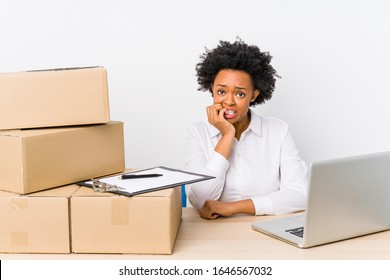 Warehouse manager sitting checking deliveries with laptop biting fingernails, nervous and very anxious. - Powered by Shutterstock