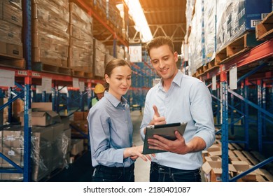 Warehouse manager talking and using digital tablet while checking product in warehouse, Logistic industry concept.