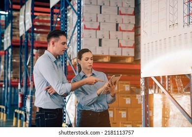 Warehouse manager talking and using digital tablet while checking product in warehouse, Logistic industry concept. - Powered by Shutterstock