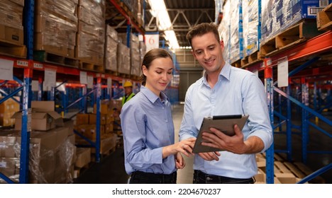 Warehouse manager talking and using digital tablet while checking product in warehouse, Logistic industry concept. - Powered by Shutterstock