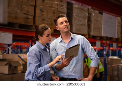 Warehouse manager talking and using digital tablet while checking product in warehouse, Logistic industry concept.