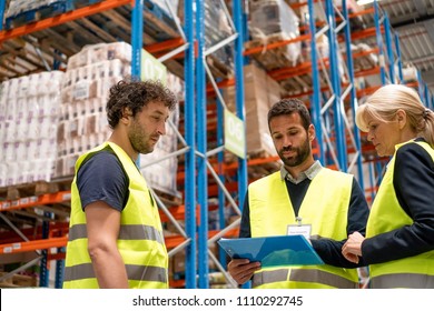 Warehouse manager and workers standing together - Powered by Shutterstock