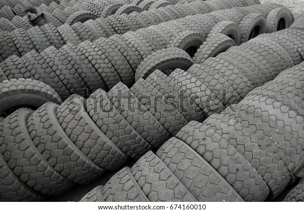 Warehouse of old\
used tires outdoors, old\
wheels