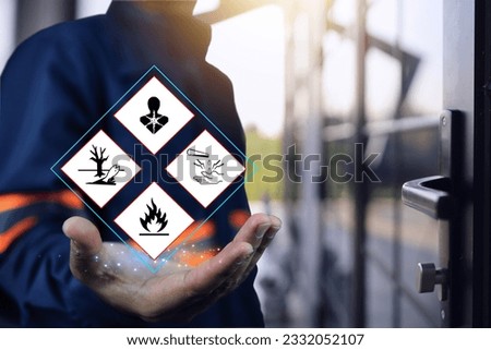 Warehouse personnel show warning signs of hazardous substances in hand, indicating preparedness in emergency situations and preparations to prevent potential dangers. MSDS and safety chemical concept.