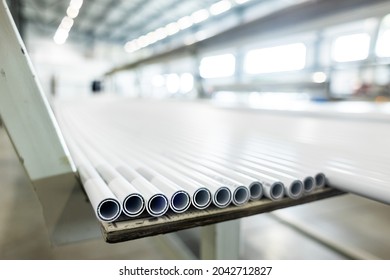 Warehouse Of Polypropylene Pipes. Workshop With Extruders For Producing Plastic Pipes. High Speed Extrusion Line Of Water Suppply And Gas Pipe. Manufacturing Facility.