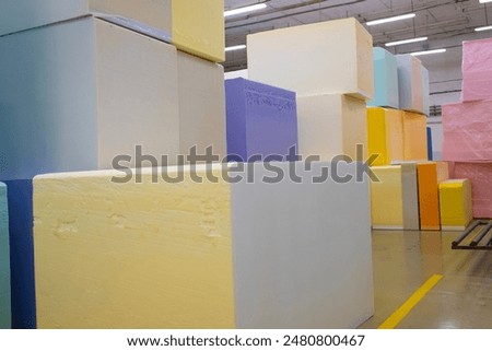 Warehouse of polyurethane foam blocks. Multicolored polyurethane foam blocks. Furniture foam rubber