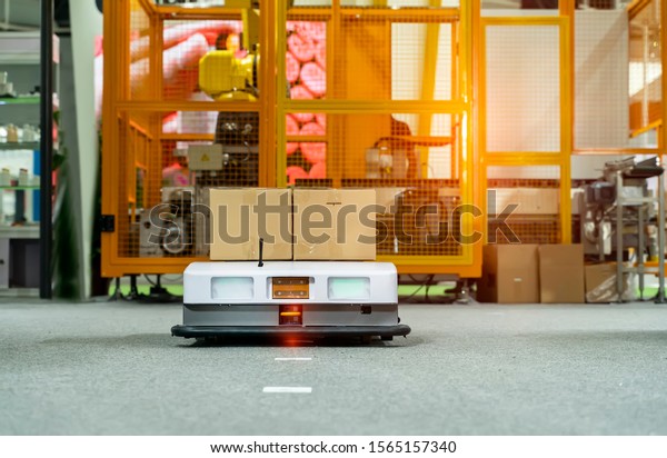 warehouse robot car carries cardboard box\
assembly in factory