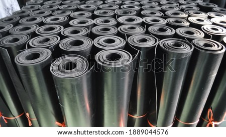 warehouse rolls of rubber. black coating rolls.