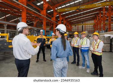 Warehouse safety meeting, people with hard hats. Industrial teamwork. - Powered by Shutterstock