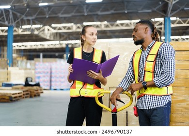 Warehouse senior supervisor or manager is talking with operation staff, warehouse workers discussing or talking together about the their works. - Powered by Shutterstock