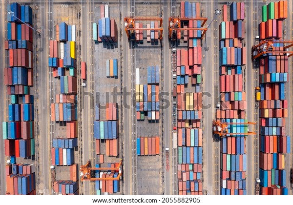 warehouse stacking containers group in a\
row and cranes load unloading, distribution center for domestic\
product and Global business cargo logistics shipping industry\
export import\
transportation.