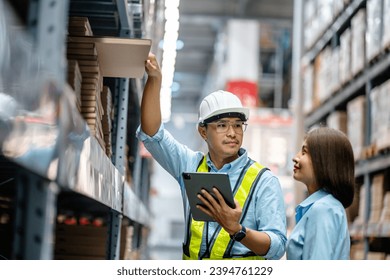 Warehouse staff working together using digital tablets to check the stock inventory on shelves in large warehouses, smart warehouse management system, supply chain, logistic network technology concept - Powered by Shutterstock