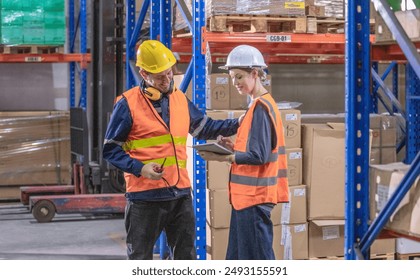 Warehouse supervisor collaborates with staff members, discussing tasks on tablet. Focusing on planning and coordinating activities to ensure efficient operations and effective inventory management. - Powered by Shutterstock