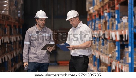 Warehouse supervisors inspecting inventory, checking stock on tablet and clipboard in distribution center, logistics operation, warehouse management, audit process and supply chain control concept.