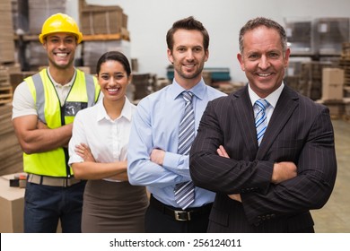 Warehouse Team Smiling At Camera In Warehouse