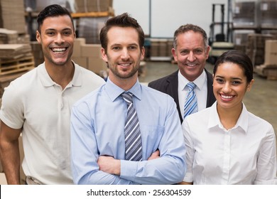 Warehouse Team Smiling At Camera In Warehouse