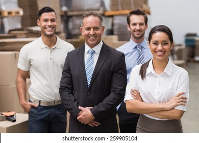 Warehouse Team Smiling At Camera In Warehouse