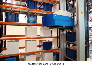 Warehouse technologies. Automated storage system. Equipment for automated warehouse. Unmanned forklift picks up box from rack. Modern technologies warehouse. Fulfillment process automation concept - Powered by Shutterstock