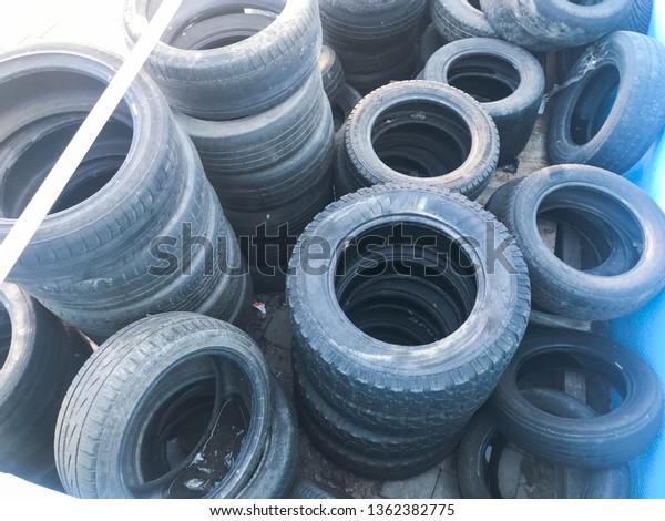 Warehouse of used black spoiled rubber, tires,\
wheels for cars.