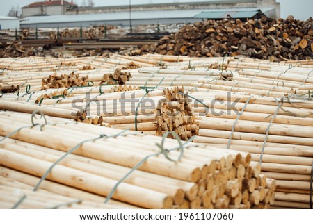 warehouse of a woodworking plant. the bundles of logs are stored and ready for transportation. a lot of processed smooth wooden bars