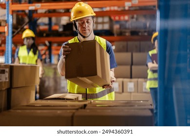 Warehouse worke in safety gear moving a box, promoting workplace inclusion. - Powered by Shutterstock