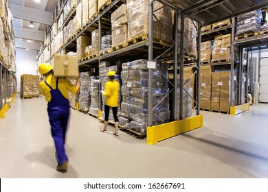 Warehouse worker with box and manager controlling products