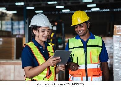 Warehouse worker checking details work on a tablet in the background warehouse.,industrial concept.