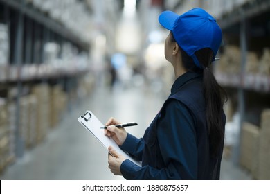 Warehouse worker checking inventory in logistics warehouse
