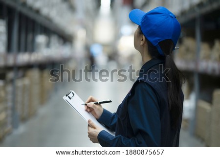 Warehouse worker checking inventory in logistics warehouse