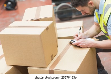 Warehouse Worker With Clipboard In Warehouse