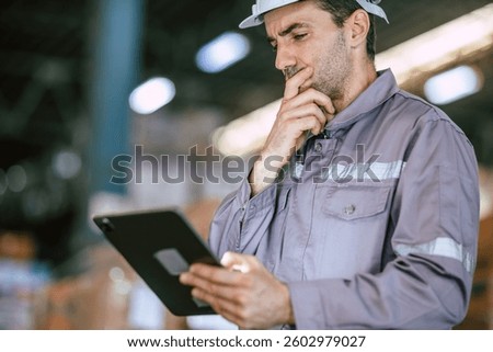 Warehouse worker, Engineer manager looking at tablet screen with thinking have a problem expression