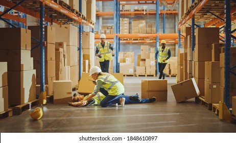 Warehouse Worker Has Work Related Accident Falls While Trying To Pick Up Cardboard Box From The Shelf. Colleagues Call For Help And Medical Assistance. Injury At Work.