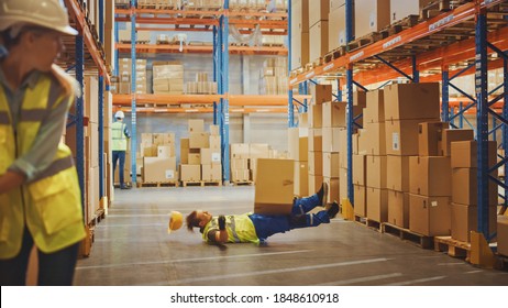 Warehouse Worker Has Work Related Accident Falls While Trying To Pick Up Cardboard Box From The Shelf. Colleagues Call For Help And Medical Assistance. Injury At Work.