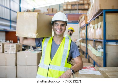 Warehouse worker holding package on the shoulder for delivery to customer. - Powered by Shutterstock