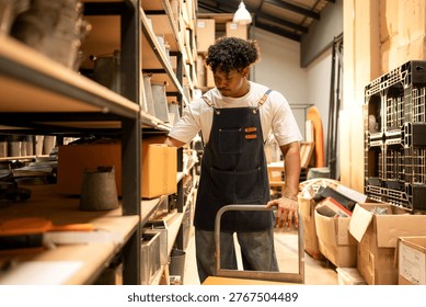 Warehouse worker lifting and moving boxes in a small business, representing logistics and manual handling