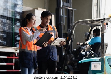 Warehouse Worker And Manager Checks Stock And Inventory With Digital Tablet Computer In The Retail Warehouse Full Of Shelves With Goods. Working In Logistics, Distribution Center.