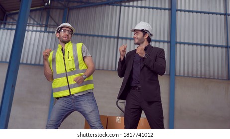 Warehouse worker and manager dancing in a large warehouse - Powered by Shutterstock