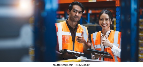 Warehouse worker and manager using digital tablet doing happy thumbs up gesture with hand. . Approving expression looking at the camera with showing success. Warehouse, import and Export Concept.