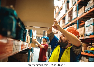 Warehouse worker organizing boxes on shelves - Powered by Shutterstock