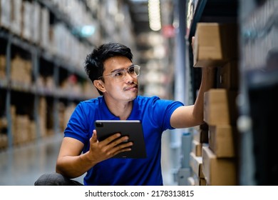 Warehouse Worker in safety suite using digital tablets to check the stock inventory in large warehouses, a Smart warehouse management system, supply chain and logistic network technology concept. - Shutterstock ID 2178313815