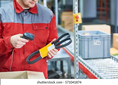 Warehouse Worker Scanning Automobile Spare Part With Laser Barcode Scanner