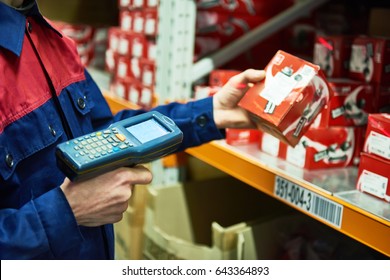 Warehouse Worker Scanning Automobile Spare Part With Laser Barcode Scanner