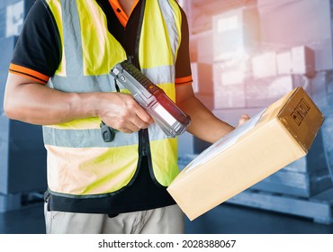 Warehouse Worker Scanning  Bar Code Scanner on Package Boxes.  Computer Work Tools for Warehouse Inventory Management. Storehouse. Shipment Pacel Boxes.	
