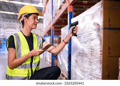 Warehouse worker scanning barcode on box in a large warehouse. Smart woman worker scanning package with barcode scanner while using digital tablet in warehouse. - Powered by Shutterstock
