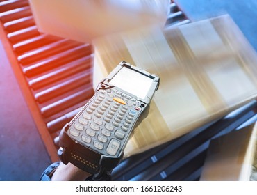 Warehouse worker scanning barcode scanner with shipment boxes on conveyor belt, packaging boxes, delivering shipment goods