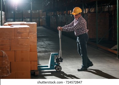 Warehouse worker selecting packages at the storehouse.Night shift. - Shutterstock ID 724572847