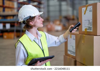 Warehouse Worker Stock Check And Barcode Scan The Goods On Wooden Pallet Wrapped With Plastic Sheet