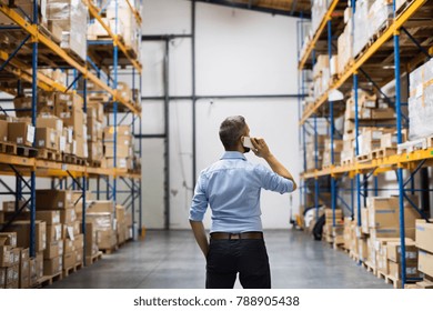 Warehouse Worker Or Supervisor With A Smartphone.